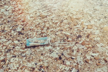 Message in a bottle on the beach, ocean.