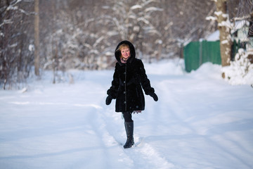Fototapeta na wymiar Young woman portrait, at snowy winter forest.
