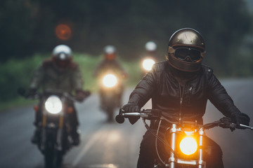 A group of motorcyclists are traveling on the rainy highway. - obrazy, fototapety, plakaty