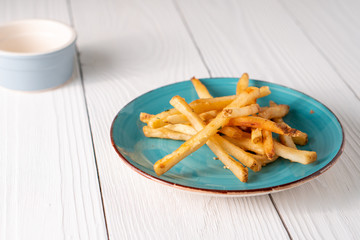 Fresh hot crispy French fries on farmhouse table