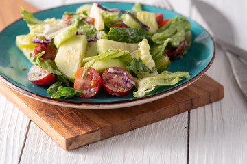 Fresh garden salad on a farmhouse table