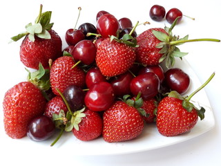 fresh strawberries  and cherries in a bowl