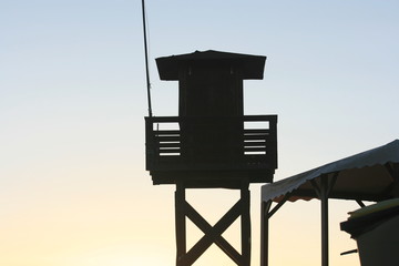 Sunset at the beach in the afternoon with vigilance tower