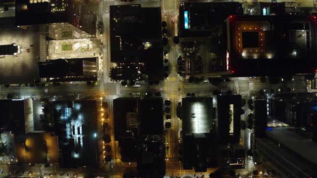 Establishing Aerial View Dow Town Looking at traffic at Night Following car  