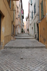 narrow cobblestone pedestrian street in old town Villefranche France