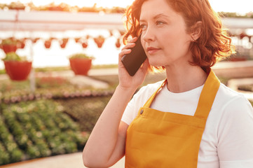 Fototapeta premium Greenhouse manager talking on phone
