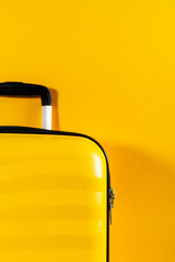 Bright and stylish cabin size suitcase on flat lay style. Easy travel with little baggage concept....