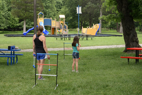 Mother And Daughter Play A Game Of Ladder Toss