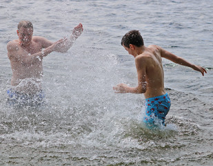Father and Son Splashing in the Lake