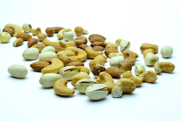 Fototapeta na wymiar nuts almonds cashew hazelnuts scattered on white background
