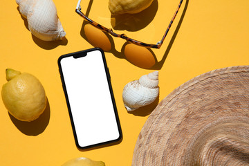 Summertime blank smartphone lay flat composition with summer holiday accessories
