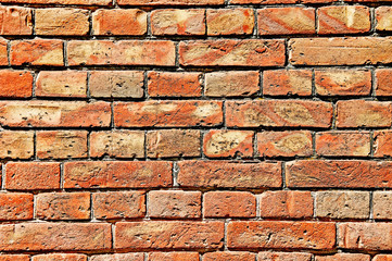 Distress old brick wall texture. Brick orange color background. Background brick texture. Design on the street. Old dirty brick with damage.