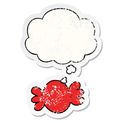 cartoon wrapped candy and thought bubble as a distressed worn sticker