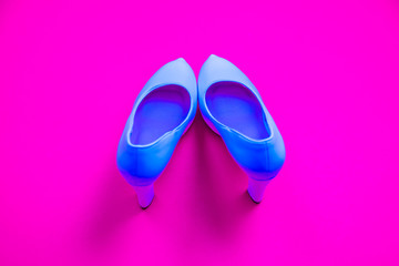 Blue high heeled shoes on pink purple background - top view - heels pigeon toe