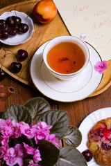 happy  morning . life style shot morning tea with  berry cake, fruits and african violet flowwer