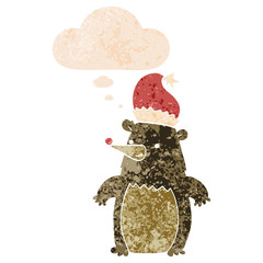 cartoon bear wearing christmas hat and thought bubble in retro textured style