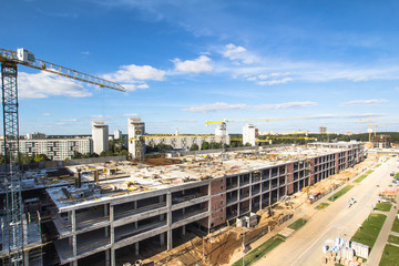 Construction area with yellow cranes at summer time.  