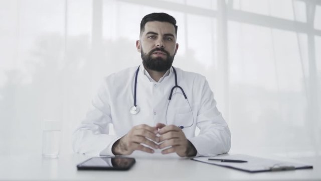 Doctor talking and looking at camera
