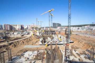 Fototapeta na wymiar Construction area with yellow cranes at summer time. 