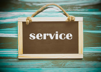 Information board with the inscription SERVICE on a wooden background.