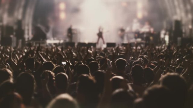 Night Rock Concert Front Row Crowd Cheering in slow motion.Epic party with enthustastic people.
