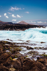 Beautiful view of the coastline of Gran Canaria, rocky shore, atlantic waves, turquise water. 