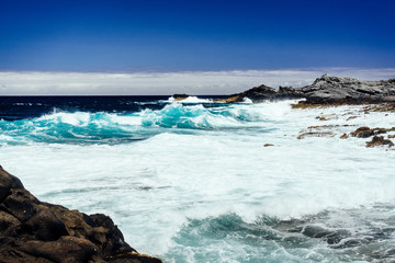 Beautiful view of the coastline of Gran Canaria, rocky shore, atlantic waves, turquise water. 