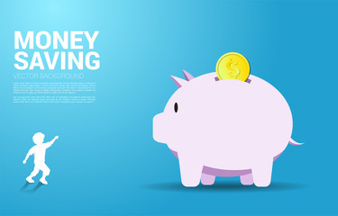 kid point finger forward to big piggy bank with coin . Concept of kid with money saving