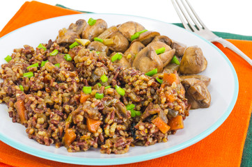 Vegetarian menu, red rice with champignons.