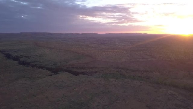 Drone flies over the barren rugged landscape of the Australian Karijini National Park.