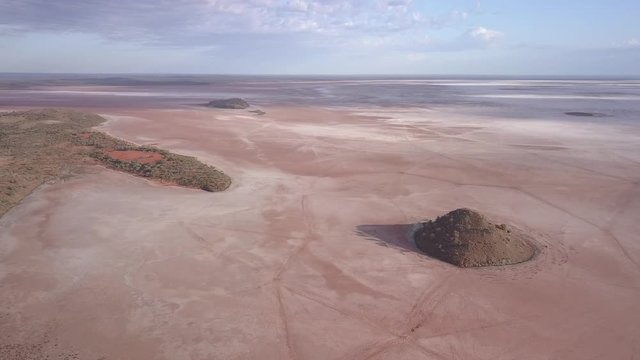 Aerial view of the lake ballard. The lonely hill in front of the lake rises from the flat sand landscape on which the Menzies Gormley statue stand