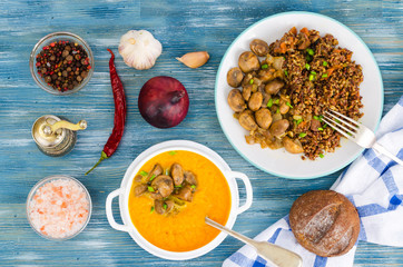 Dishes with mushrooms in plates on table