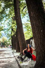 Attractive woman wearing inline skaters relaxing with shaker