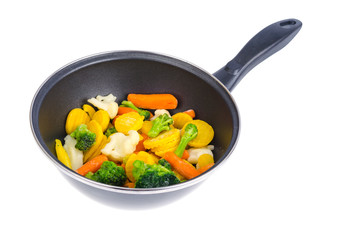 Frying pan with mix of frozen vegetables, isolated on white background.