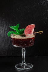  cocktail in a glass with grapefruit and mint