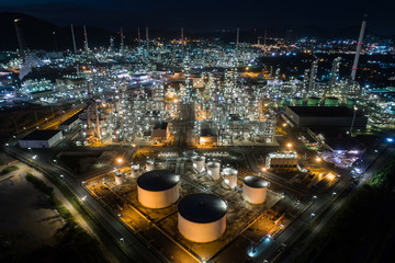 Fototapeta na wymiar Aerial view oil storage tank with oil refinery factory industrial. Oil refinery plant at night. industry factory concept and transportation.