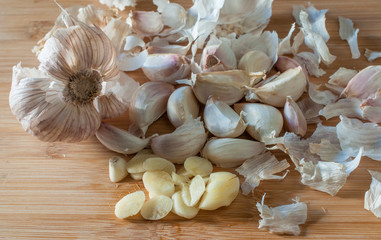 Peeled garlic on a wooden cutting board