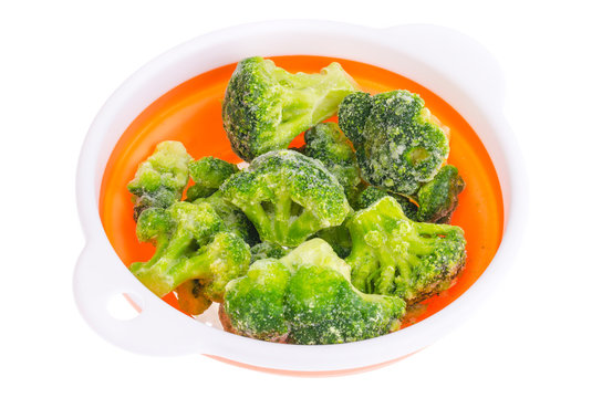 Frozen broccoli florets in bowl.