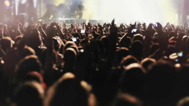 Night Rock Concert Front Row Crowd Cheering in slow motion.Epic party with enthustastic people.