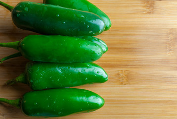 Top view of jalapeños chile on a wooden cutting board