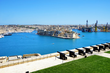 high angle sunny cityscape view of Mediterranean island Malta over blue sky