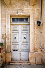 close up retro style old house door of Mediterranean architectural culture in Mediterranean island Malta