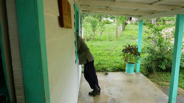 Man leaning into store window in Cuba
