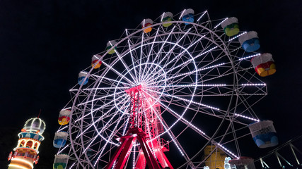 Ferris wheel at night at an amusement park.