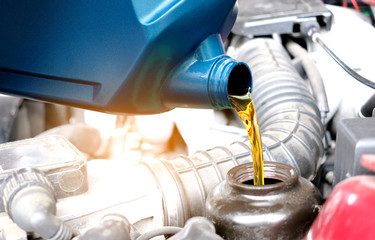 Refueling and pouring oil quality into the engine motor car Transmission and Maintenance Gear .Energy fuel concept.