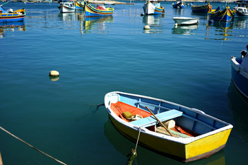 Fototapeta na wymiar close up colorful traditional wooden fishing boats in harbor of Mediterranean island Malta