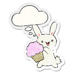 cute cartoon rabbit with muffin and thought bubble as a distressed worn sticker