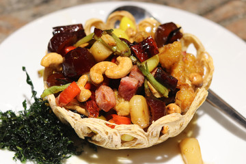 Stir fried mixed Chinese fruit & nut combination in taro nest.  One of the most popular Chinese dishes in Thailand and Asia.