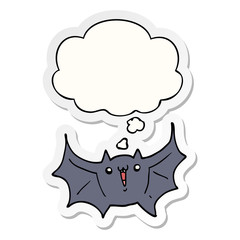 cartoon happy vampire bat and thought bubble as a printed sticker