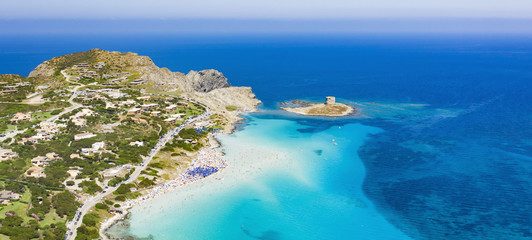 Stunning aerial view of the Spiaggia Della Pelosa (Pelosa Beach) full of colored beach umbrellas and people sunbathing and swimming in a beautiful turquoise clear water. Stintino, Sardinia, Italy.